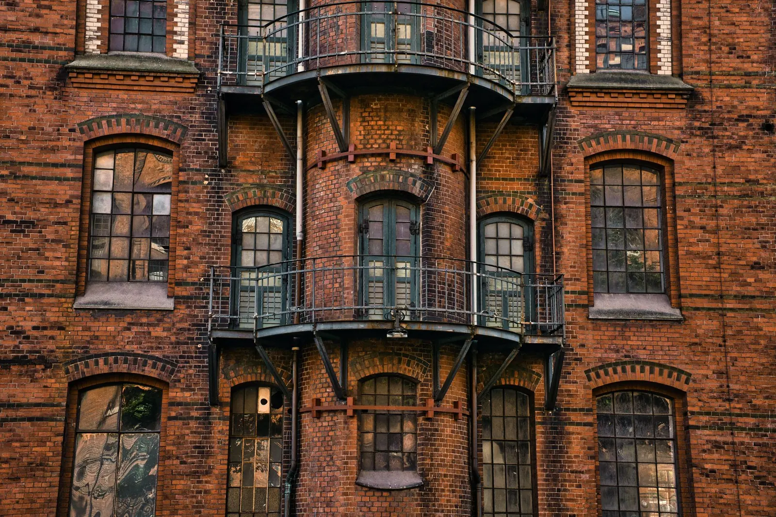 Red brick building with wrought-iron balconies